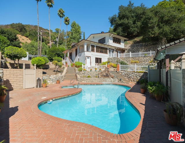 view of swimming pool with a patio