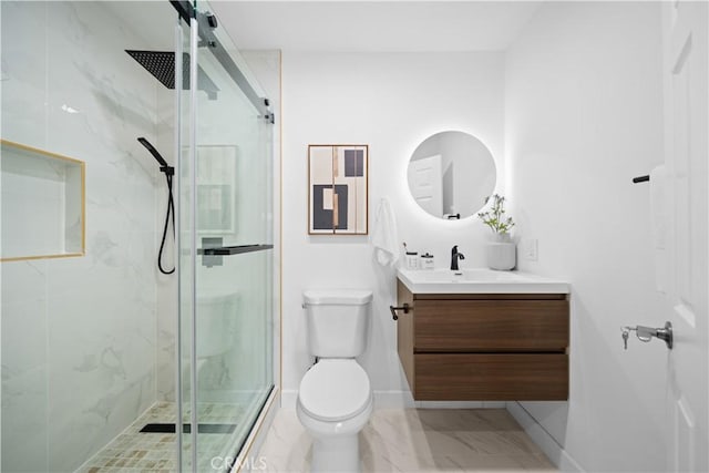 bathroom featuring toilet, a shower with door, and vanity