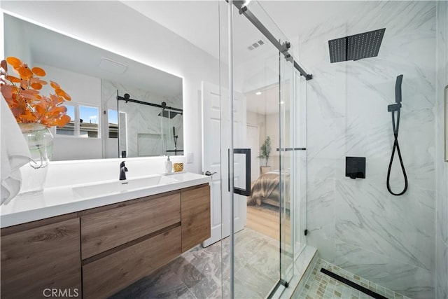 bathroom featuring walk in shower and vanity