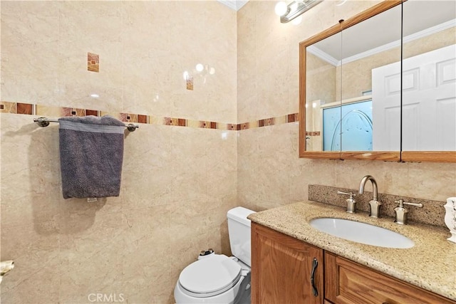 bathroom with tile walls, crown molding, vanity, and toilet