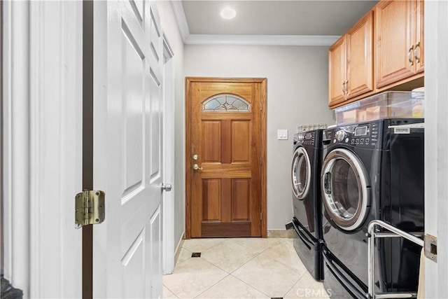 laundry area featuring washer and dryer, ornamental molding, light tile patterned floors, and cabinets