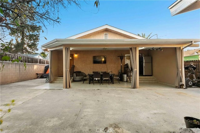 back of property with a patio