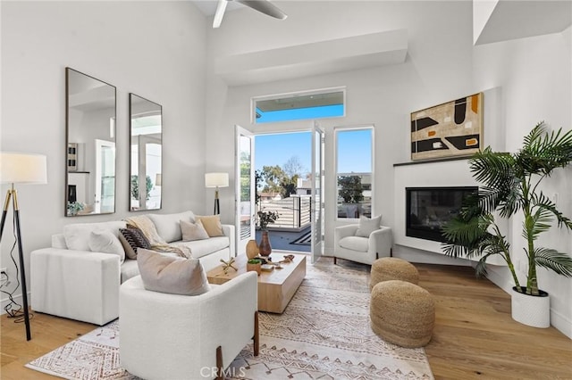 living room featuring a high ceiling and light wood-type flooring