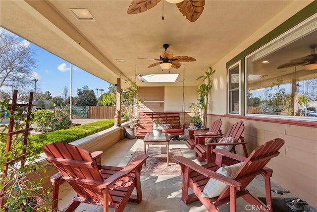 view of patio with fence and a ceiling fan