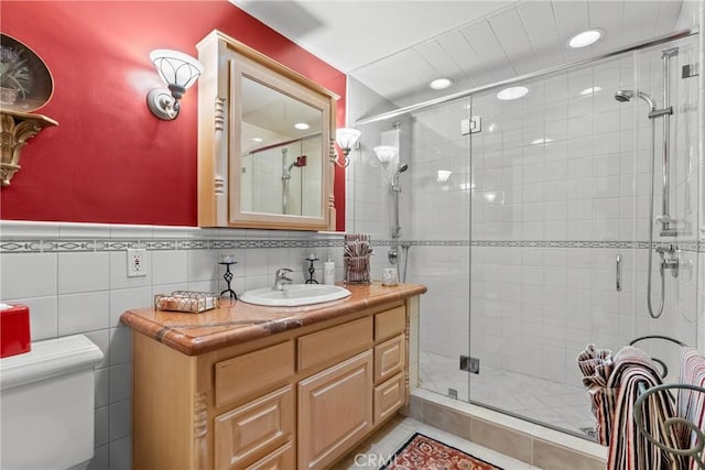 full bathroom with toilet, a shower stall, and vanity