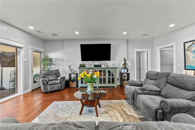 living room featuring wood finished floors, visible vents, and recessed lighting