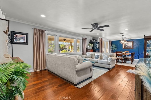 living room featuring dark wood-type flooring, recessed lighting, crown molding, and baseboards