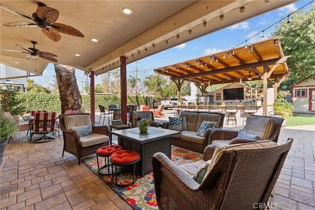 view of patio / terrace with an outdoor living space and ceiling fan