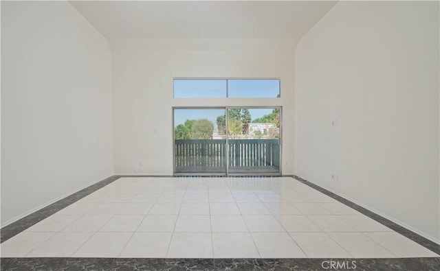 spare room featuring light tile patterned flooring