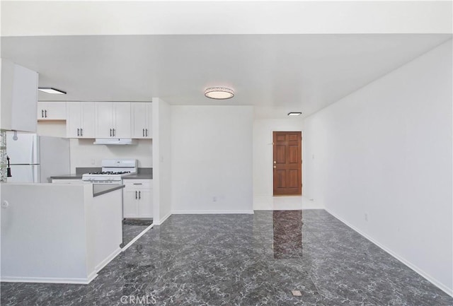 kitchen with white appliances and white cabinets