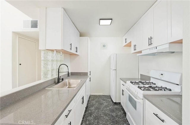 kitchen with sink, white cabinetry, light stone countertops, and white gas range