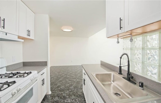 kitchen featuring sink, white cabinets, and white gas range