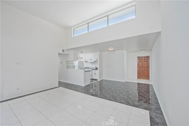 unfurnished living room with a high ceiling