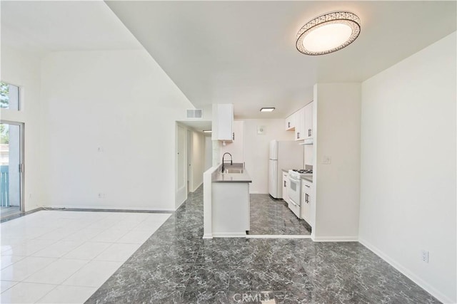 kitchen with white cabinets, white appliances, and sink