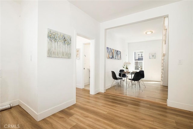 hall with hardwood / wood-style floors