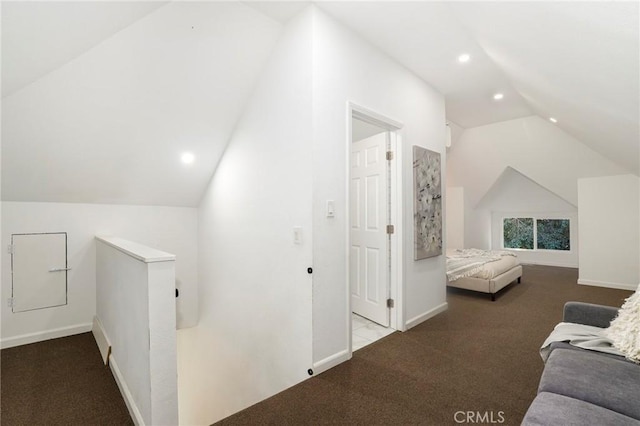 additional living space featuring vaulted ceiling and light carpet