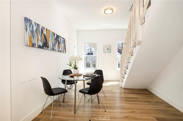 dining space with hardwood / wood-style floors