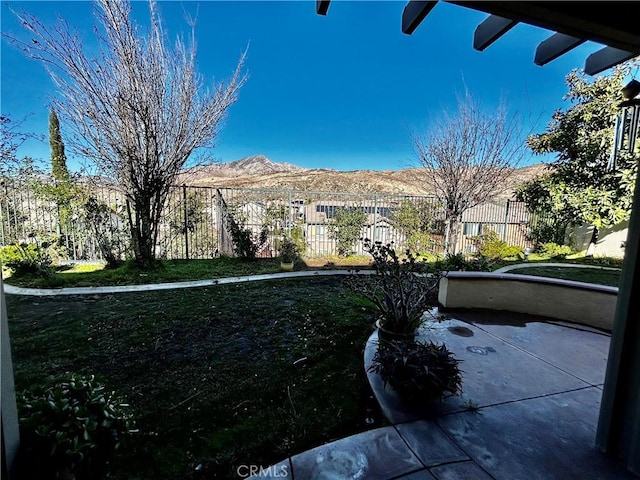 view of yard with a patio and a mountain view