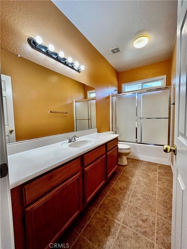 full bathroom with toilet, a textured ceiling, enclosed tub / shower combo, and vanity