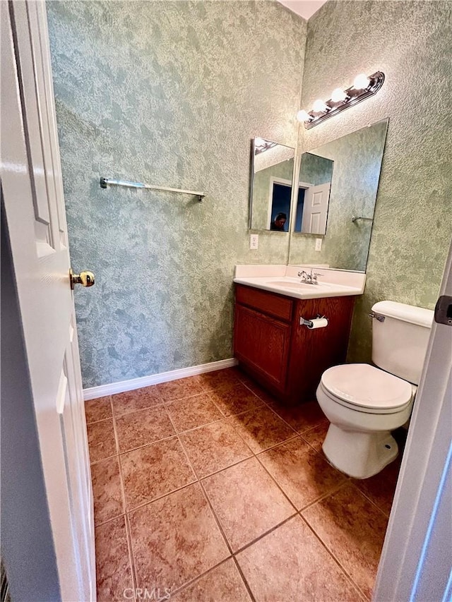 bathroom featuring vanity, tile patterned floors, and toilet