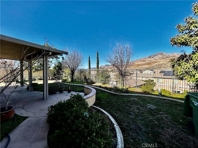 view of yard with a patio area and a mountain view