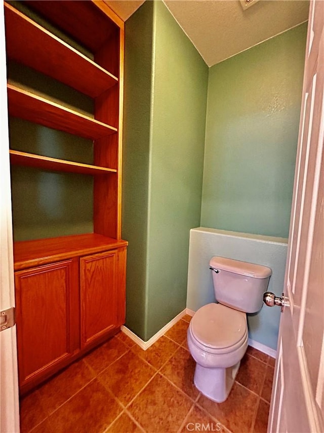 bathroom featuring toilet and tile patterned flooring