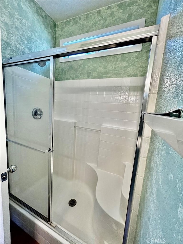 bathroom with a shower with shower door