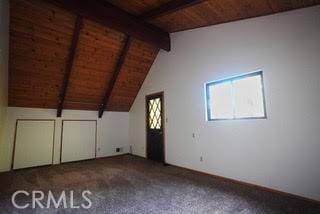 bonus room with wooden ceiling, carpet, and vaulted ceiling with beams