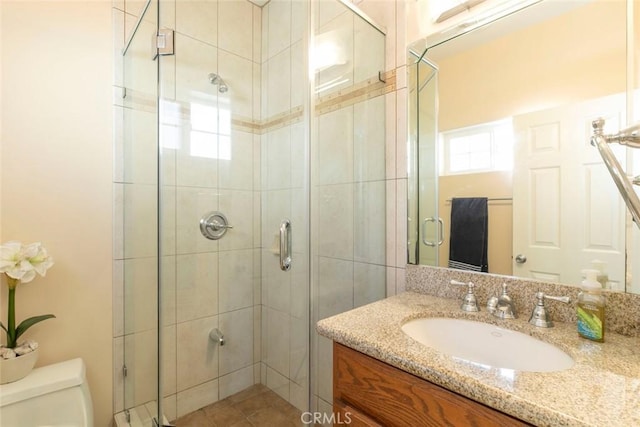 bathroom with walk in shower, vanity, and toilet