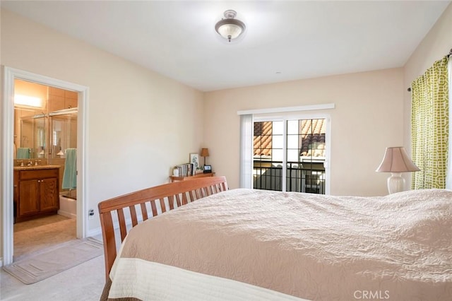 carpeted bedroom featuring ensuite bath, sink, and access to outside