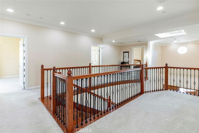 hallway with crown molding and light colored carpet