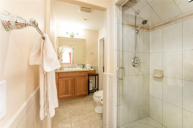 bathroom with walk in shower, vanity, and toilet