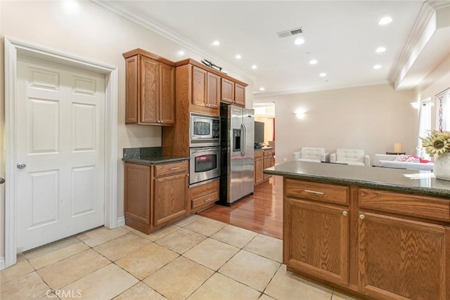 kitchen with stainless steel appliances, crown molding, and light tile patterned floors