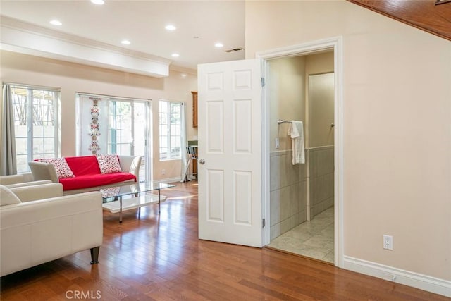 interior space with wood-type flooring and ornamental molding