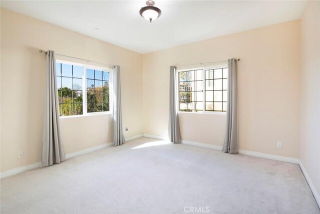 spare room featuring light colored carpet