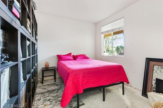 bedroom featuring concrete flooring