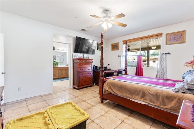 bedroom with ceiling fan, ensuite bathroom, and light tile patterned flooring