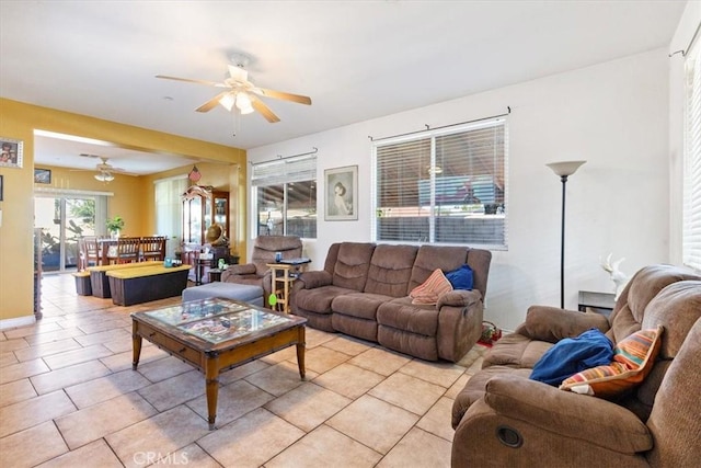 tiled living room with ceiling fan