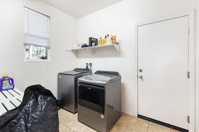 washroom with washer and clothes dryer and light tile patterned floors