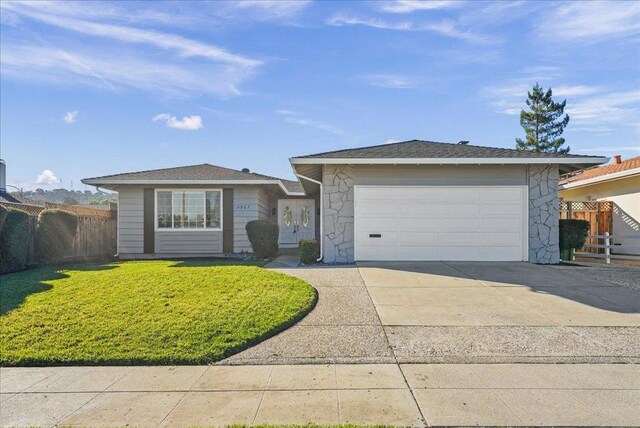 single story home with a front yard and a garage