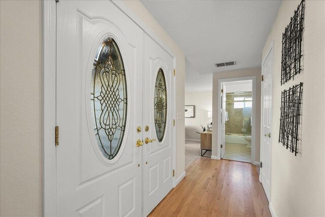 entryway with light hardwood / wood-style floors