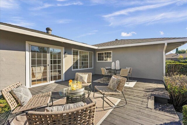 wooden terrace with an outdoor fire pit