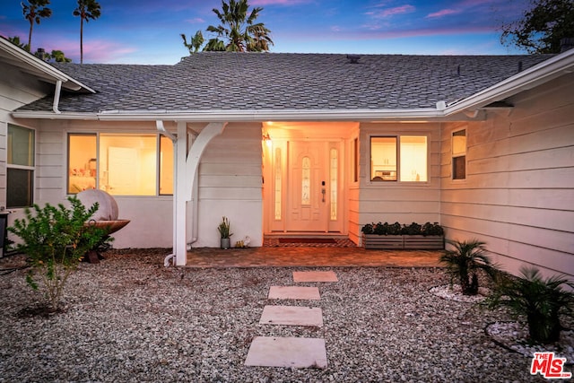 view of exterior entry at dusk