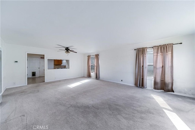 unfurnished living room featuring ceiling fan and light carpet