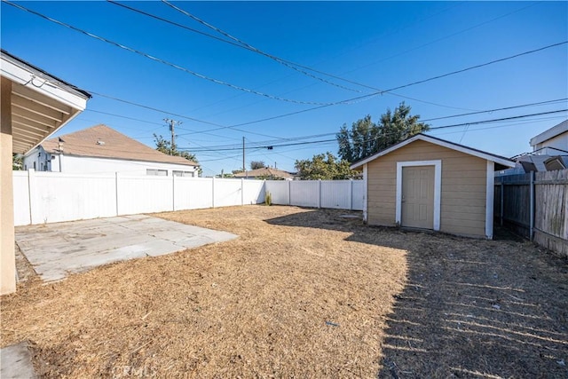 view of yard featuring a patio and a storage shed