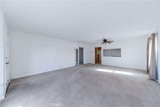 unfurnished living room with ceiling fan and light colored carpet