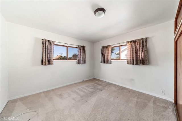 unfurnished room with light carpet and plenty of natural light