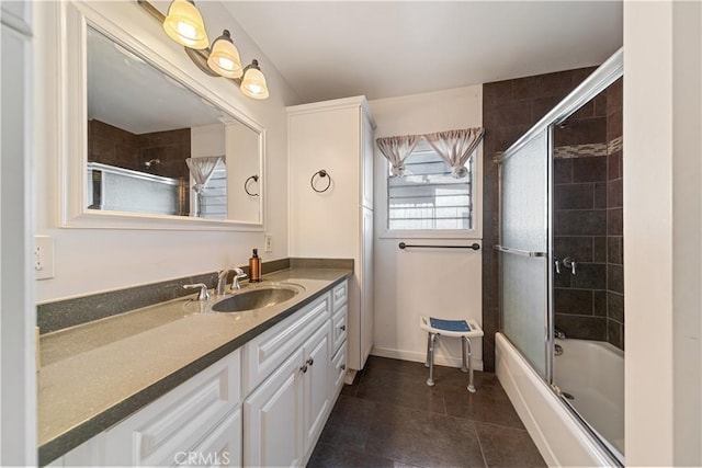 bathroom featuring enclosed tub / shower combo, tile patterned floors, and vanity