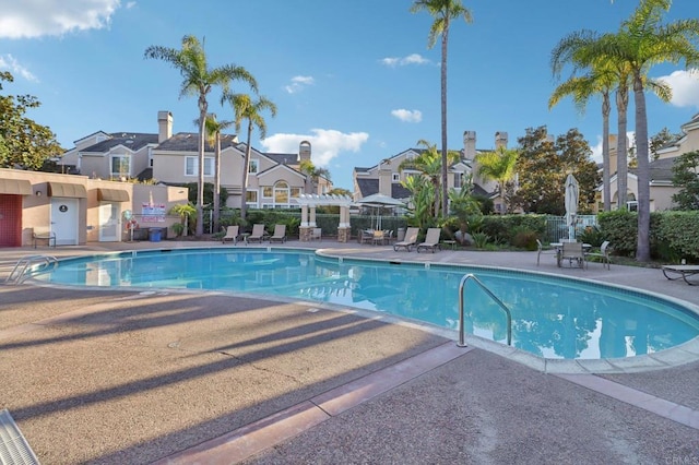 view of swimming pool with a pergola and a patio