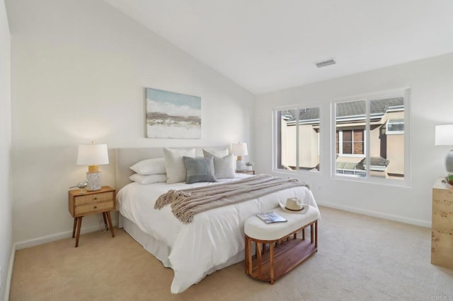 bedroom with lofted ceiling and light carpet